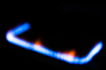 Flame of blue gas burning on a black isolated background.Gas burner blue industrial gas.