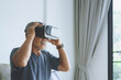 © eggeeggjiew - Asian Senior adult man wearing VR goggles, virtual reality headset