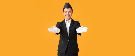 Wall Mural - Beautiful stewardess on orange background