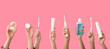 © Pixel-Shot - Many hands with toothbrushes, paste, mouth rinse, jaw model and dental floss on pink background