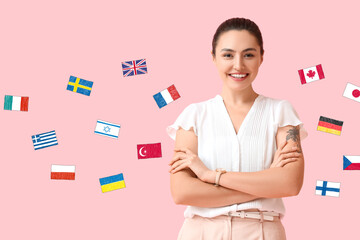 Sticker - Beautiful young woman and different flags on pink background. Studying of foreign languages