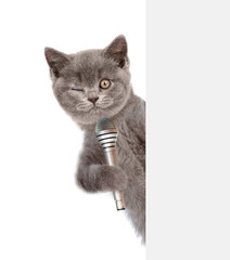 Poster - Winking cat holds microphone behind empty white banner. isolated on white background