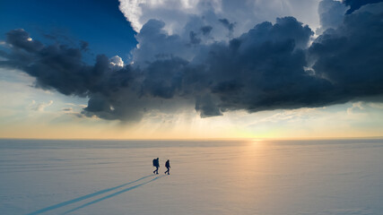 Wall Mural - The two travelers walking through the arctic icy field