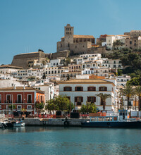 Port, Old Town And Castle Of Ibiza. Sa Marina Neighborhood And The Historic Complex Of Dalt Vila With Blue Sky And Sea.