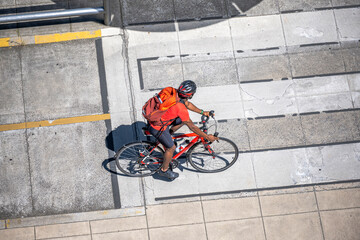 Wall Mural - Black cyclist on a road bike takes a walk along the bike path on a city street