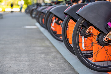 Wall Mural - Range of bicycles for rent await enthusiast passengers ready to ride the streets of the modern city.