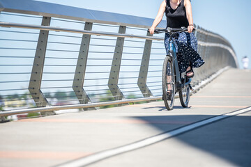 Wall Mural - Woman cyclist takes care of her health and rides her bike along the bike path at Tilikum Crossing Bridge in Portland