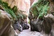 Dana Biosphere Reserve in Jordan. Amazing rocks in Wadi Ghuweir Canyon. Silhouette of hiking person on trail. 