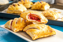puff pastry with strawberries on wooden background. food concept