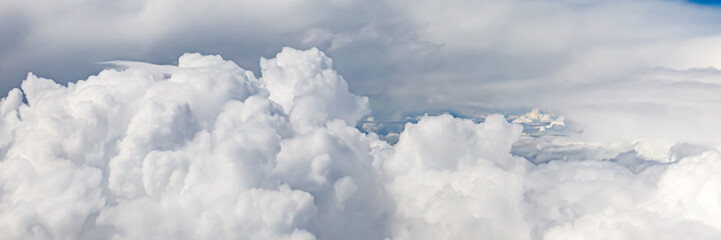 Canvas Print - Clouds from above. View from airplane.  blue sky view from plane. sky wallpaper with space for your text . Aerial view of the blue sky. High in the Heavens.   View from Airplane Window