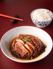 Braised Pork Belly with Preserved Mustard Green on with rice red background