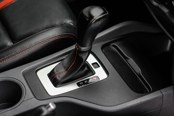 automatic transmission shift selector in the car interior. Closeup a manual shift of modern car gear shifter. 4x4 gear shift