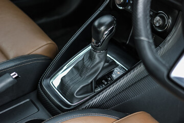 automatic transmission shift selector in the car interior. Closeup a manual shift of modern car gear shifter. 4x4 gear shift