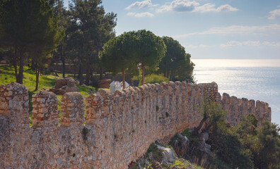 Wall Mural - Alanya, turkey, winter walk by mediterranean sea. medieval fortress in the city of Alanya and wall
