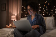 canvas print picture - technology, bedtime and rest concept - happy smiling woman in pajamas with laptop computer working in bed at night