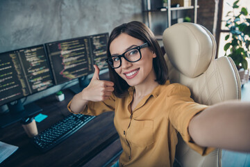 self-portrait of attractive smart clever cheerful girl cyber engineer showing thumbup solution at wo