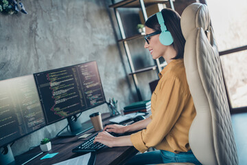 Profile side view portrait of attractive cheery girl editing data interface operating system software at workplace workstation indoors