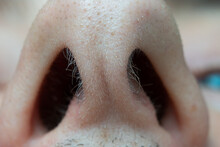 Caucasian Male Open Nasal Nostrils Macro Close Up Shot. Short Nasal Hairs, Low Angle View, Unrecognizable Face