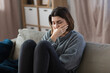 © Syda Productions - mental health, psychological problem and depression concept - stressed woman sitting on sofa at home