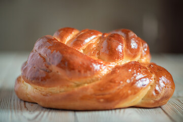 Fresh baked homemade organic bread close-up on a wooden background.