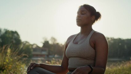 Wall Mural - Woman practicing breathing exercise at the park in summer day 