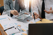 © Natee Meepian - Asian business adviser meeting to analyze and discuss the situation on the financial report in the meeting room.Investment Consultant, Financial advisor and accounting concept