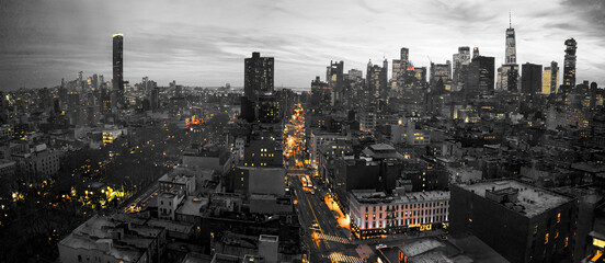 Sticker - Yellow lights of the New York City skyline shining against a black and white cityscape in Lower Manhattan NYC