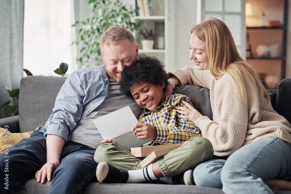 Happy African child getting adoption agreement from his foster parents ...