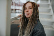 Leinwandbild Motiv Portrait of a freckled teenager girl with dreads making a gum bubble