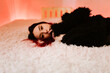 © Cavan Images - Portrait Of Beautiful Woman Lying On Bed