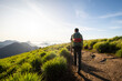 © Cavan Images - Beautiful view to man with backpack hiking on rainforest mountain top
