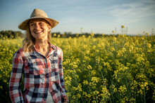 Portrait Of A Girl Smiling In A Rapeseed Field At Sunset