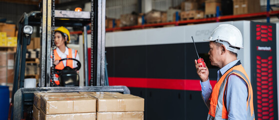 Warehouse workers with a forklift working  in the warehouse., Industrial and industrial concept.