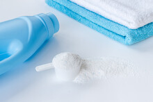 White Washing Powder With Towels And A Laundry Conditioner Bottle