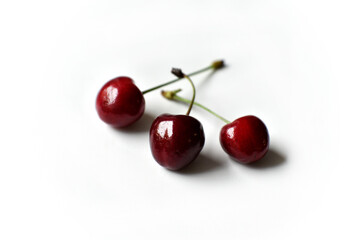 Wall Mural - Juicy red ripe cherries on a white background.
