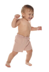 Wall Mural - Cute baby in shorts learning to walk on white background