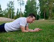 © JoseManuel - A young man in a white T-shirt posing in a park.