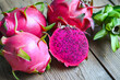 pink purple dragon fruit cut half on wooden with pitahaya background , fresh dragon fruit tropical in the asian thailand healthy fruit concept