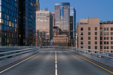 Empty urban asphalt road exterior with city buildings background. New modern highway concrete construction. Concept of way to success. Transportation logistic industry fast delivery. Los Angeles. USA.