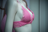 Fototapeta Sypialnia - Closeup of pink bra on mannequin in a fashion store for women showroom