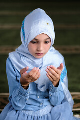 Wall Mural - Muslim girl praying inside the mosque.