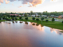 Playing Field Turned Into A Peaceful Dam With Sunset Reflections During Flood And River Backflow