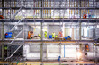© FOLIO - Workers on scaffolding at construction site