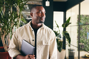 Confident Male Advertising Marketing Or Design Creative Or Tech Start Up In Modern Office Smiling To Camera