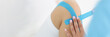 © H_Ko - Physiotherapist put kinesiology blue tape on patient knee