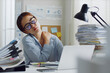 © Nattakorn - Tired Asian office employee massaging neck and shoulder muscles fatigued from using laptop computer for a long time, office syndrome concept