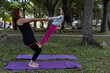 © Amilciar - Latin American mom and daughter have fun in the park doing yoga and exercise together
