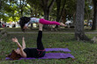 © Amilciar - Latin American mom and daughter have fun in the park doing yoga and exercise together