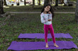 © Amilciar - Latin American girl ready to do her yoga practice in the park