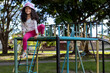 © Amilciar - Latin American girl with positive attitude playing in the playground